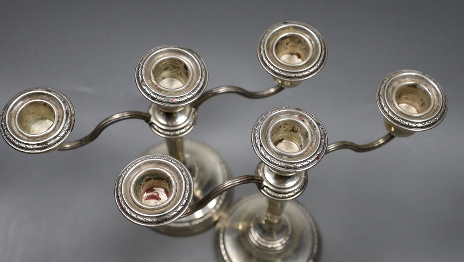 A pair of Elizabeth II silver candelabra, with loaded bases, makers Elkington & Co, Birmingham 1967, height 21cm